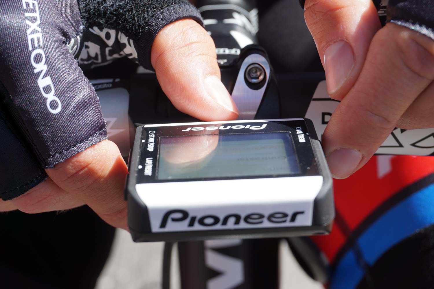 Simon Geschke adjusts his Pioneer power meter before a stage of the 2015 Tour Down Under.
